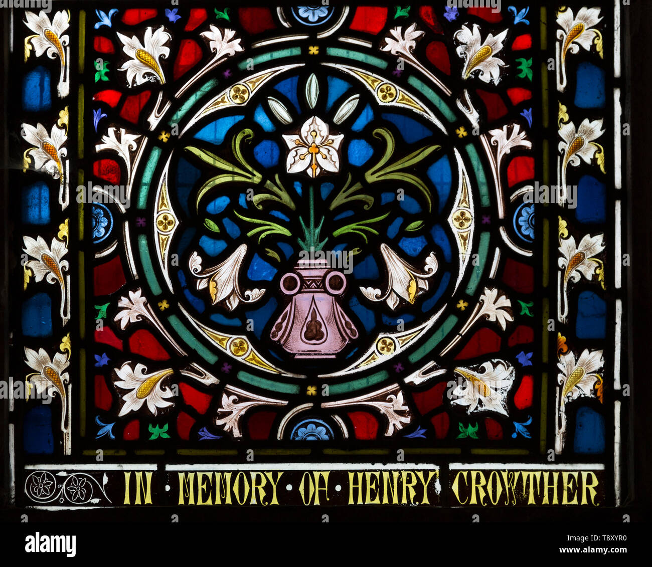 Ornamental stained glass window lily flowers and floral decoration, church, Stanton St Bernard, Wiltshire, England, UK Lavers and Barraud 1867 Stock Photo