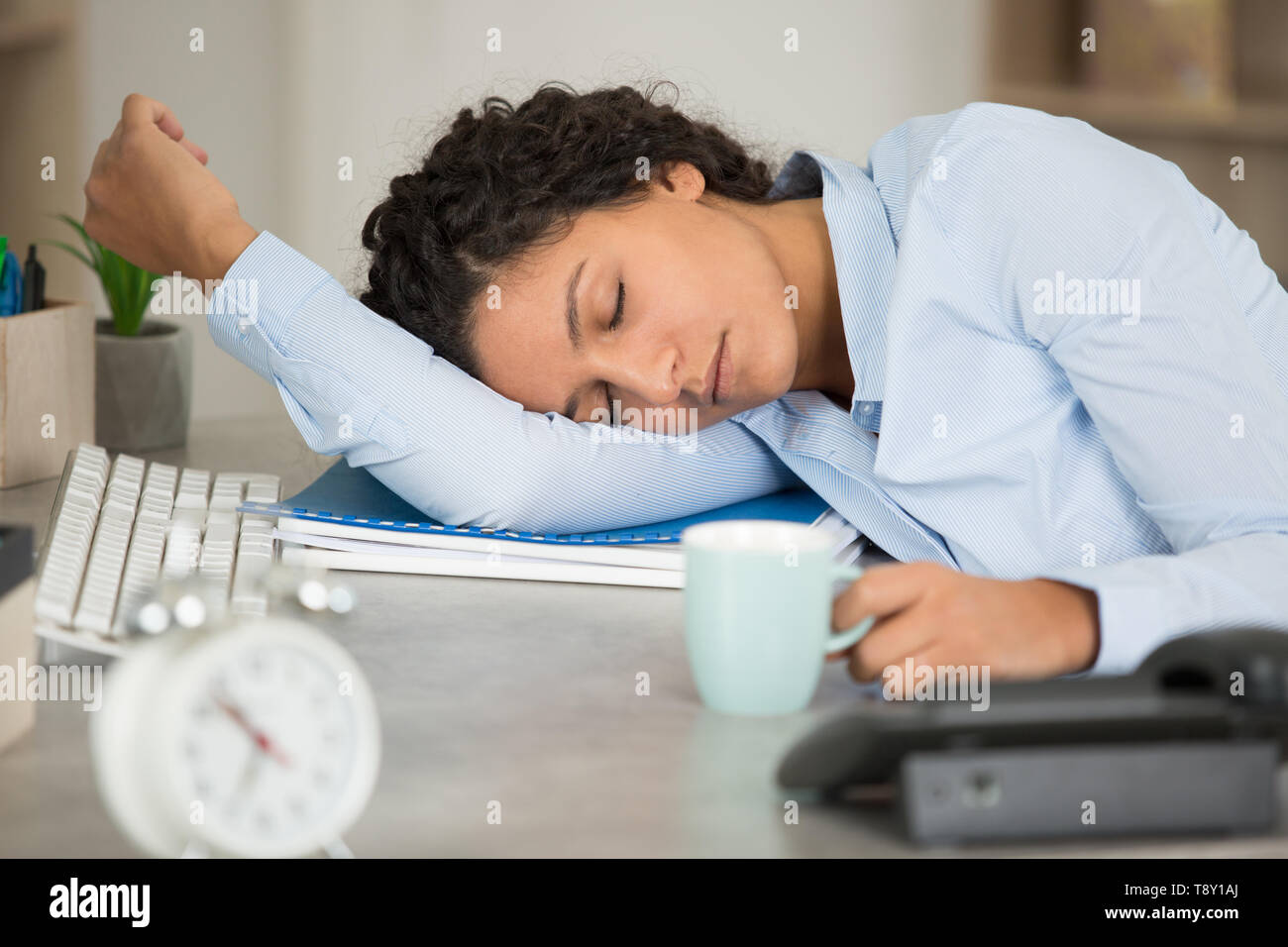 woman fallen asleep at her office desk Stock Photo