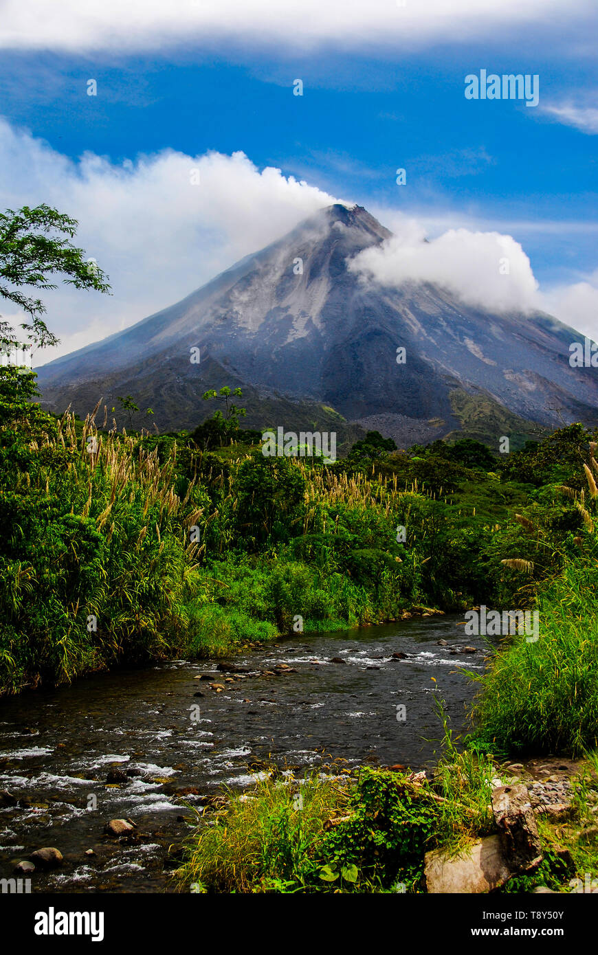 View of Arenal volcano and a small stream in Costa Rica. Stock Photo