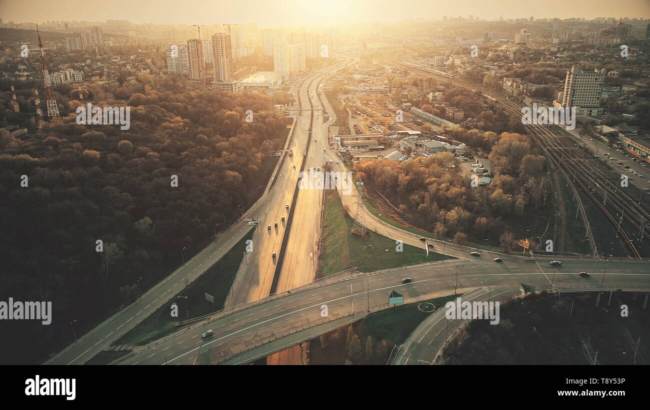 Urban Car Road Traffic Congestion Aerial View. City Street Motion Lane, Drive Navigation Overview. Busy Cityscape Speed Route with Forest Park Around. Travel Concept Drone Flight Shot Stock Photo