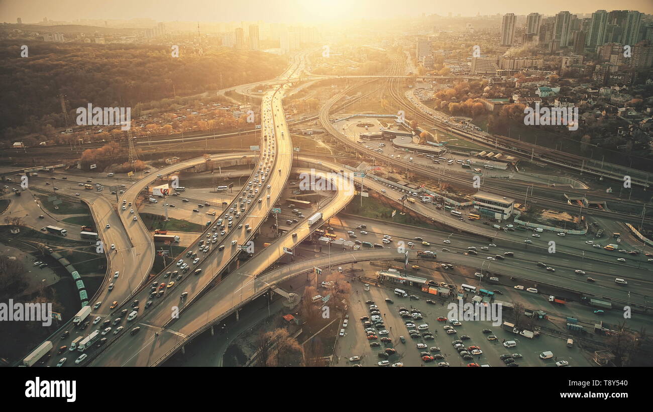 City Road System with Sight Traffic Jam Aerial View. Urban Congested Highway Lane Transport Navigation Scene. Busy Downtown Building Vehicle at Sunset. Travel Concept Drone Flight Shot Stock Photo
