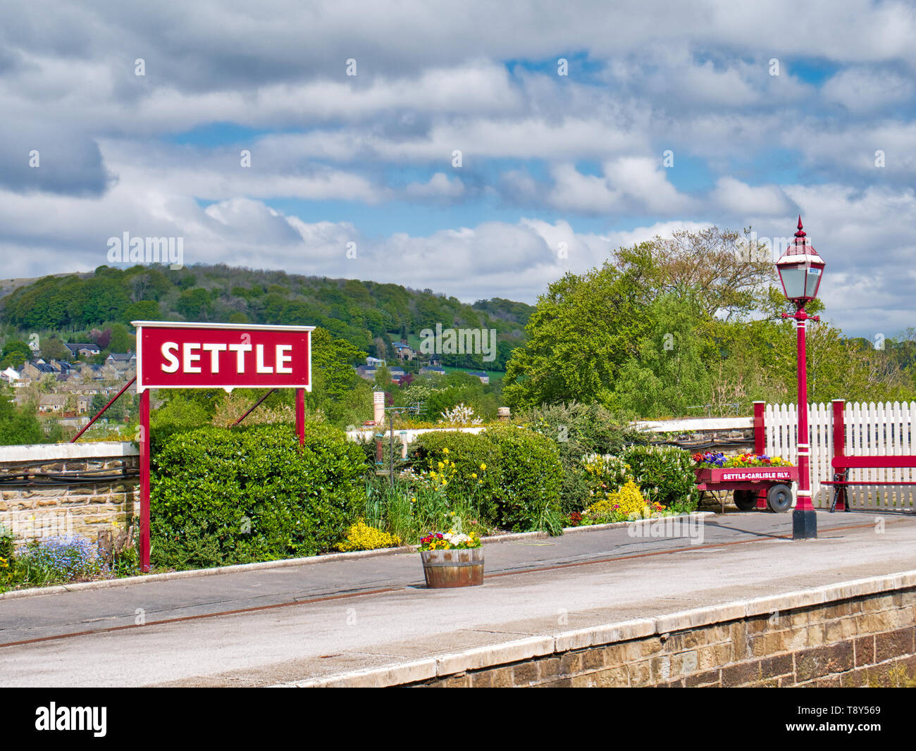 Settle Railway Station in the Yorkshire Dales in northern UK, with Sugar Loaf Hill in the background. Stock Photo