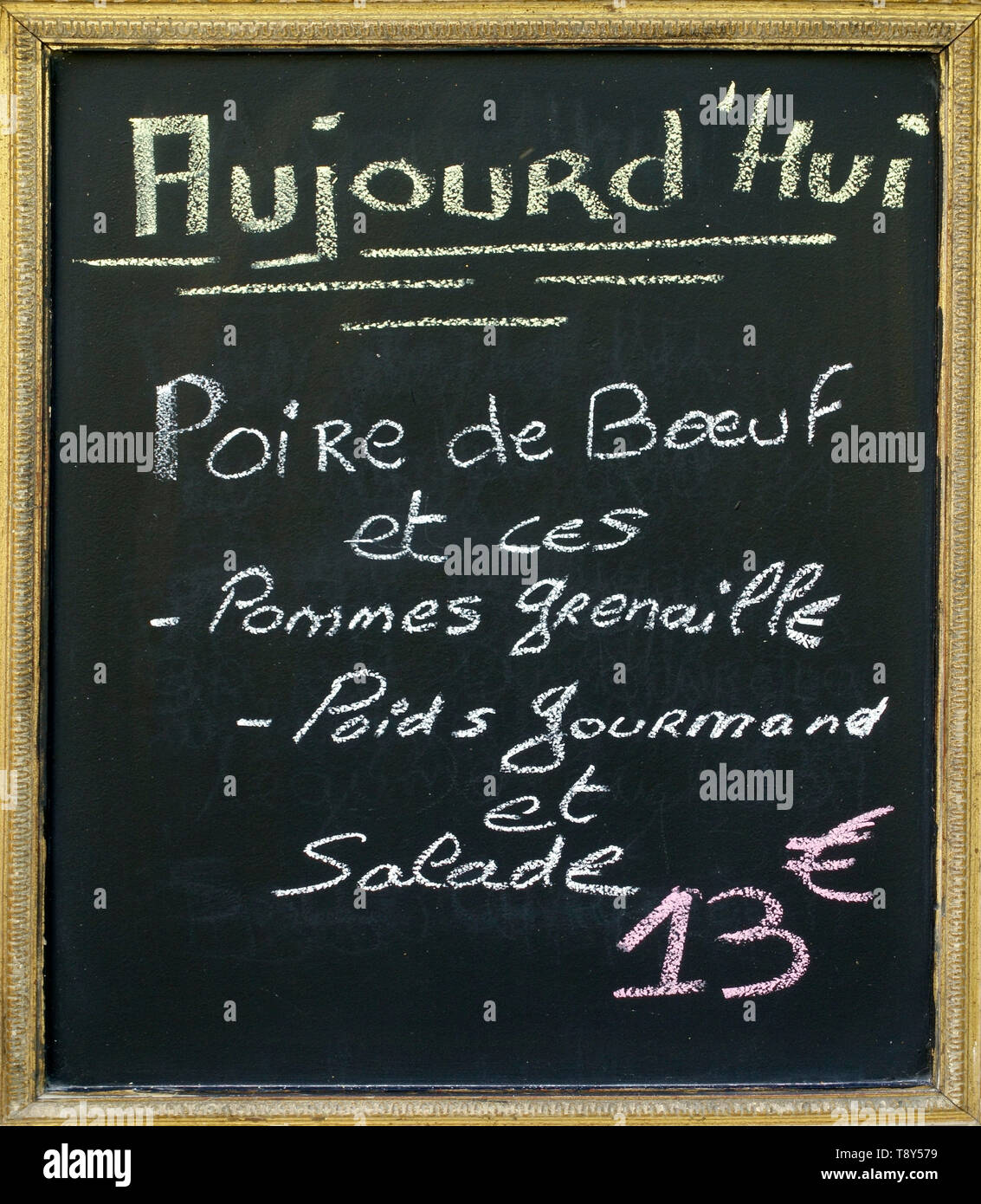 Menu blacboard outside a French restaurant. In French handwritten is announced what the menu of the day will be Stock Photo