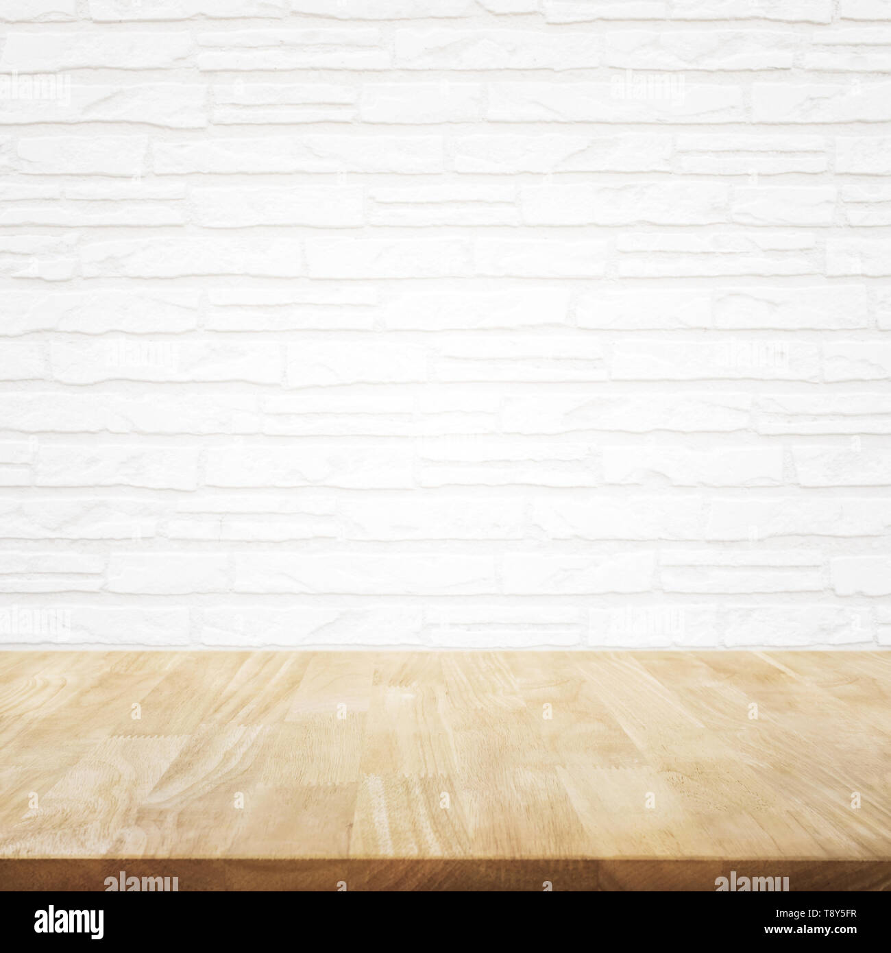 Empty wood table top with brick wall background. Stock Photo