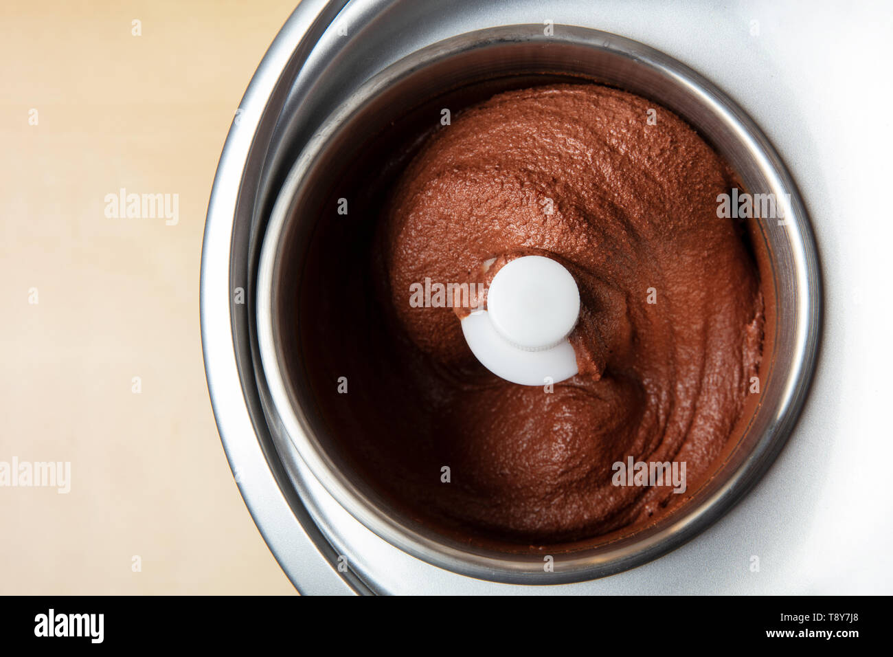 Homemade chocolate ice cream is prepared in an ice cream maker Stock