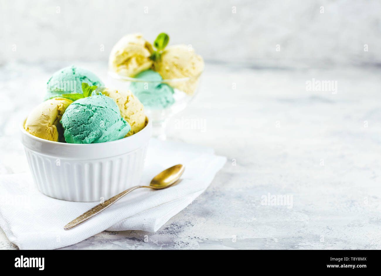 Scoop of refreshing lemon sorbet icecream with zest and mint on a white  background Stock Photo - Alamy