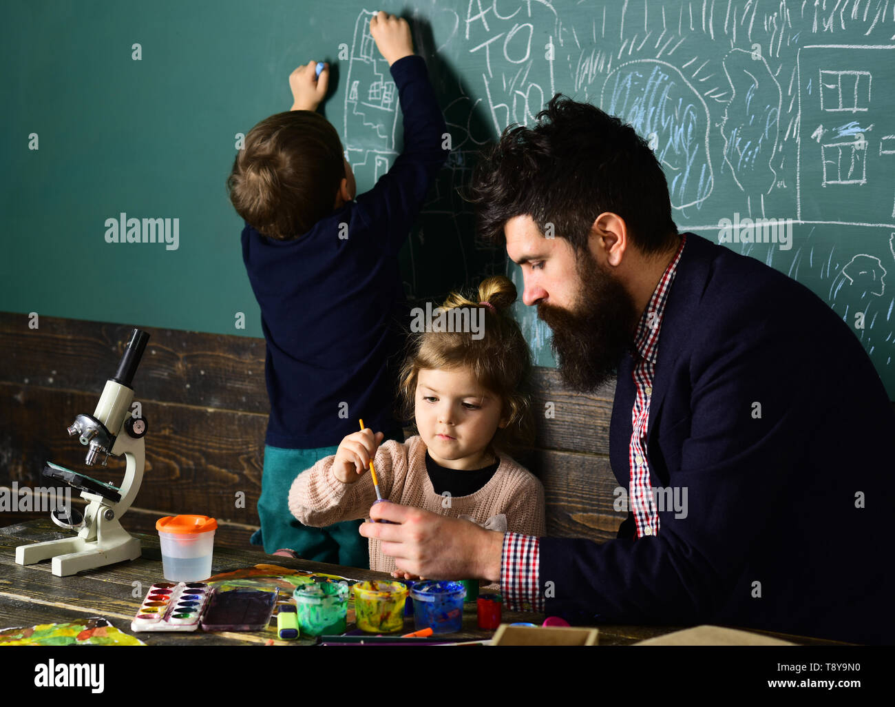 High school or college students studying and reading together in ...