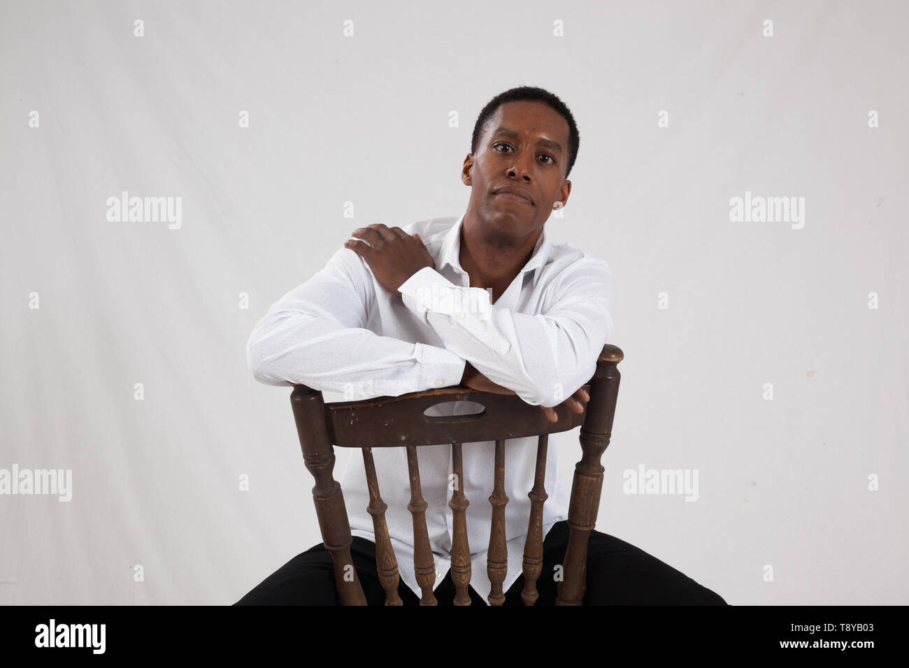 Man sitting backwards chair hires stock photography and images Alamy