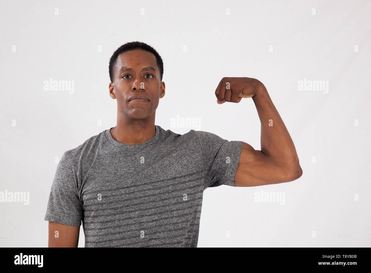 Man flexing arm muscles hi-res stock photography and images - Alamy