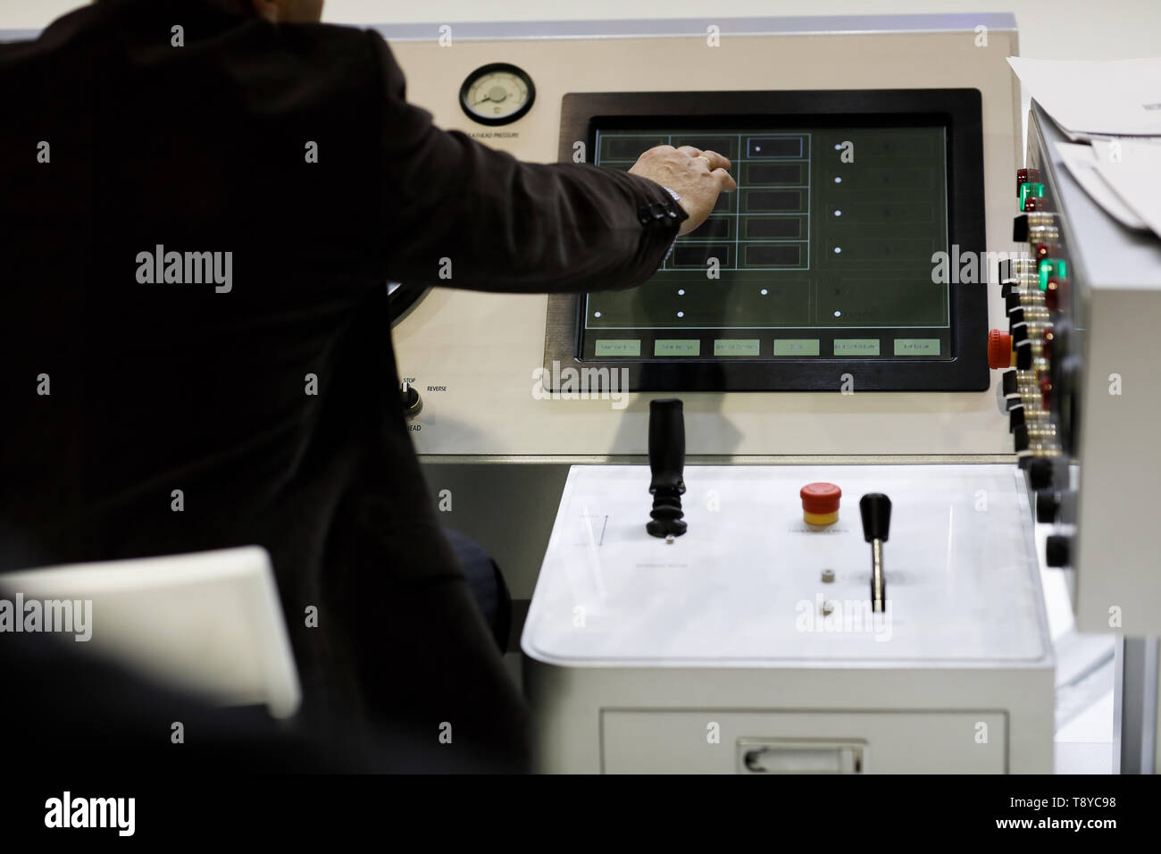 Engineer at control operation desk of a drilling rig. Selective focus