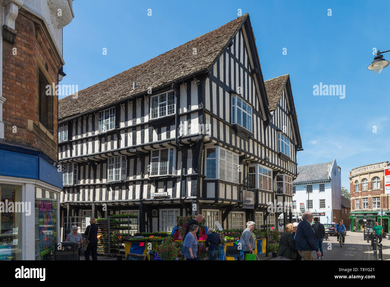 Large black and white timberframed building in the centre of the
