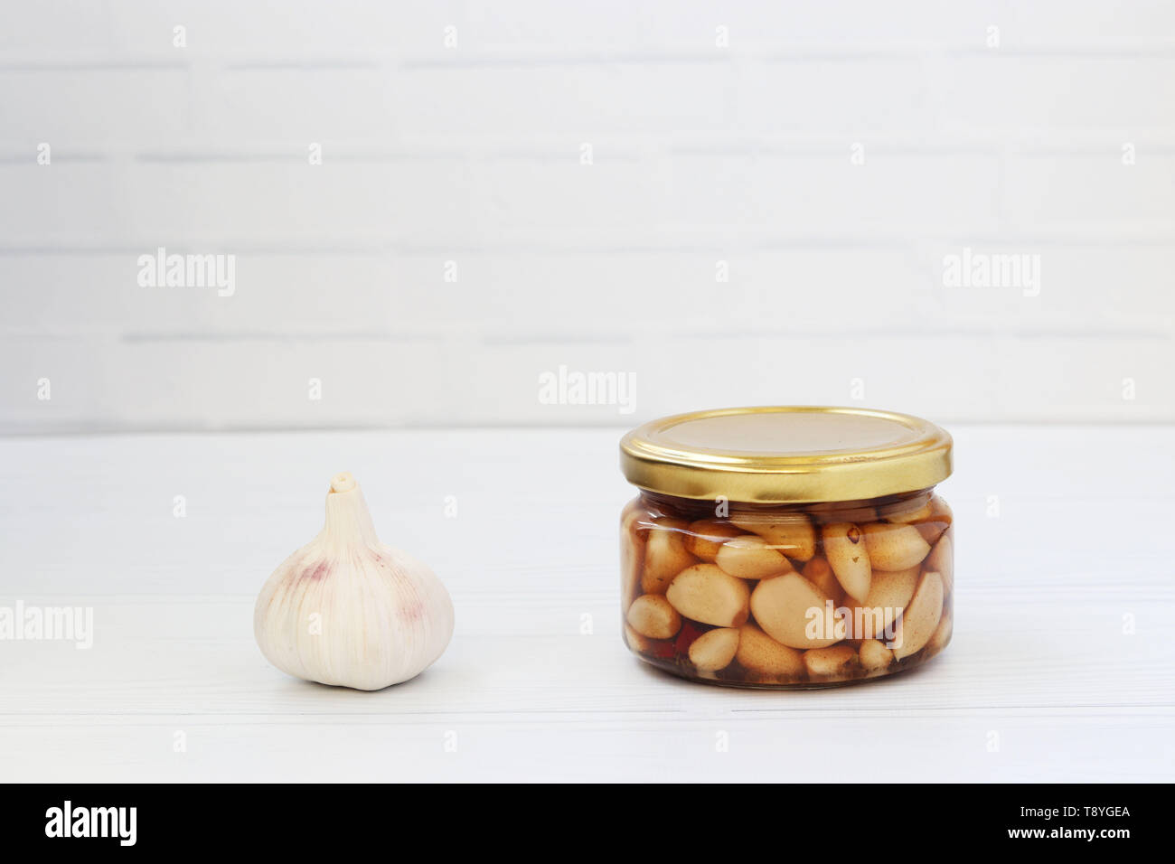 Marinated garlic in a jar on a white background Stock Photo Alamy