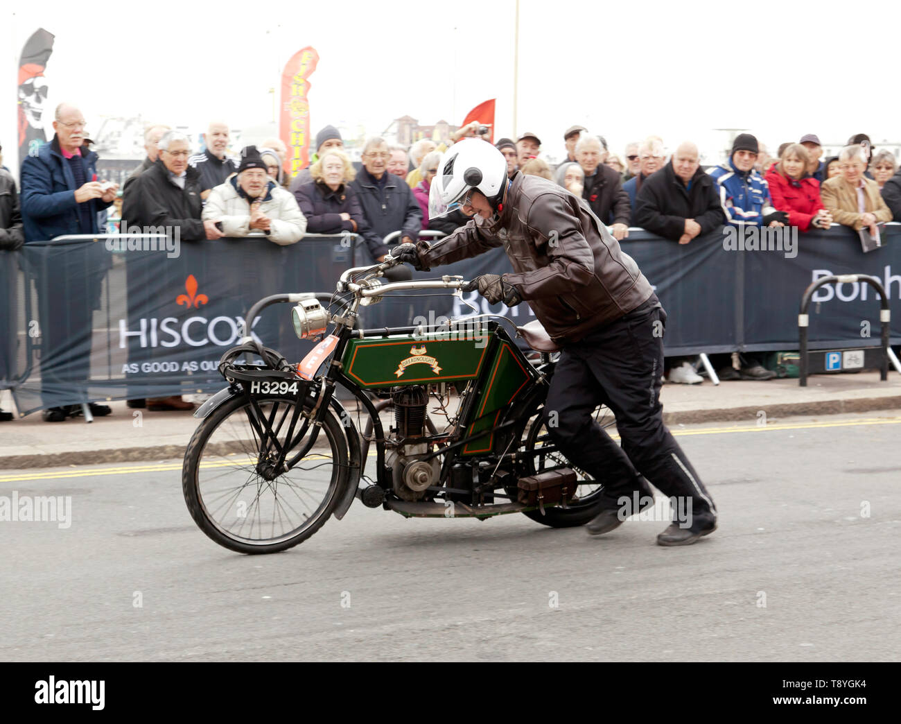 A veteran 1903 Dreadnought  motorcycle being push-started, in  Madera Drive, at the finish of the 2018  London to Brighton Veteran Car Run. Stock Photo