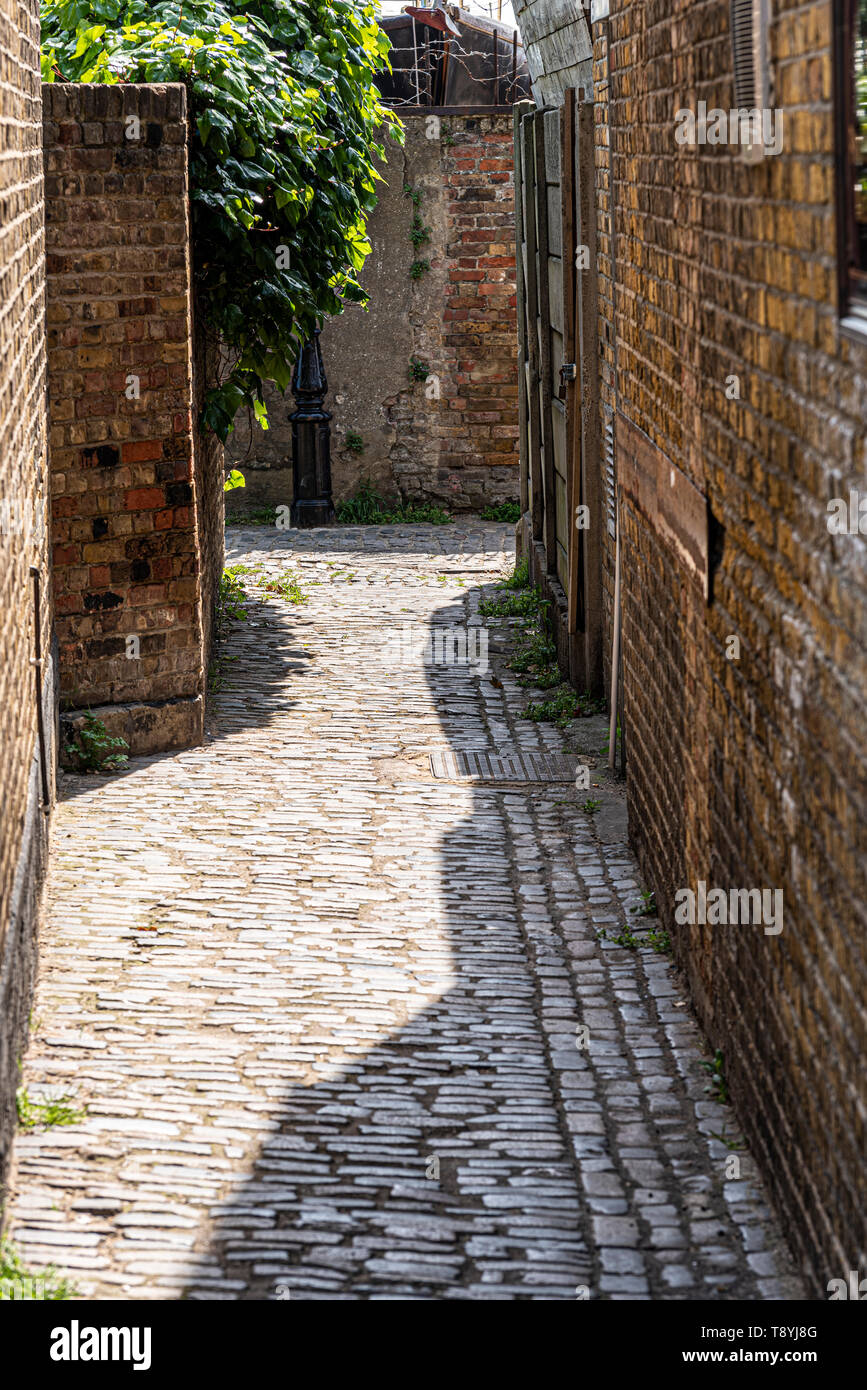 Narrow passage between old buildings in Old Leigh, Leigh on Sea, Essex, UK. Historic cobblestone walk Stock Photo
