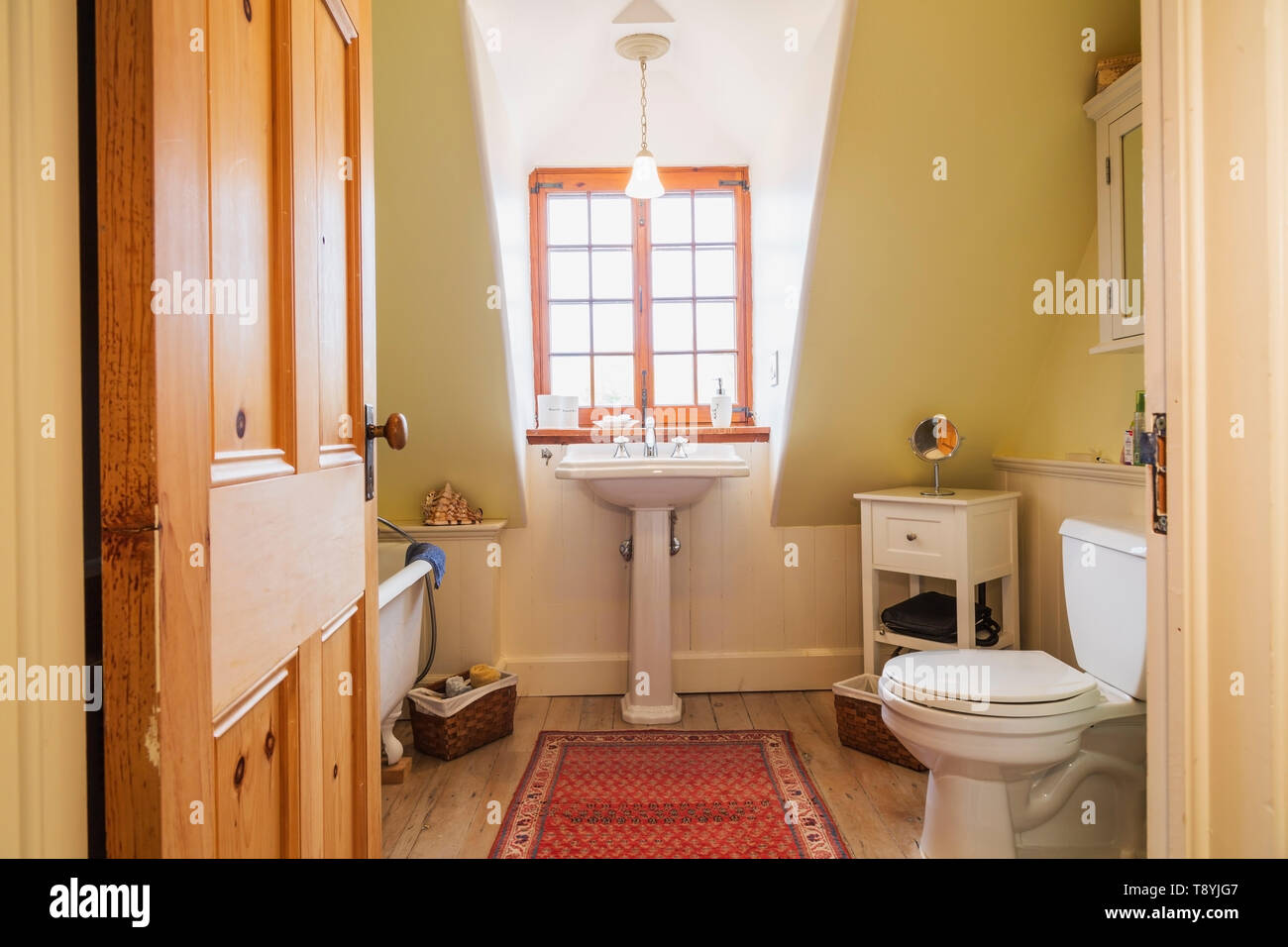 Freestanding roll top bathtub, pedestal sink and toilet in upstairs