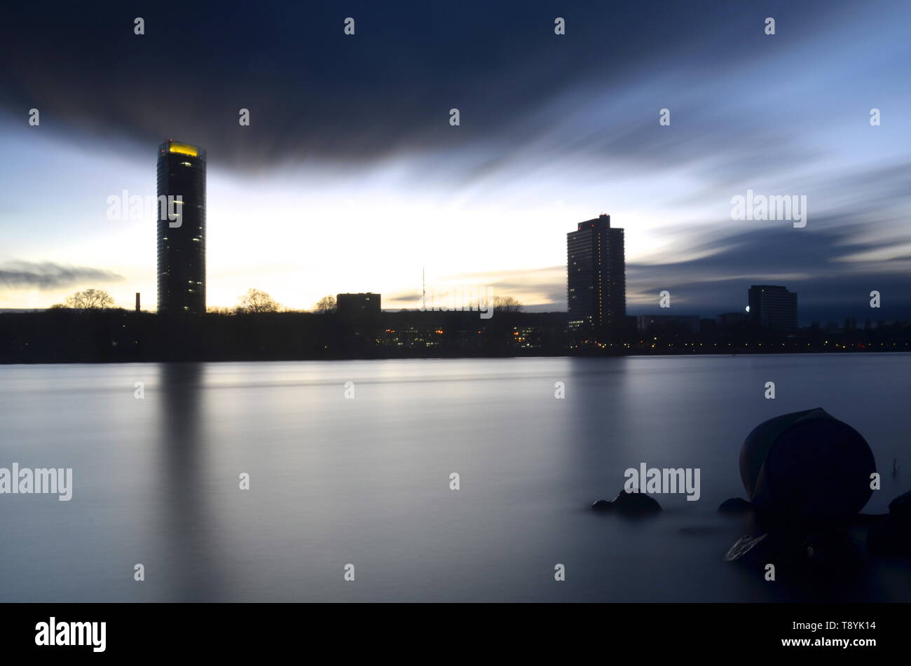 Bonn city skyline seen from rhine river, long exposure clouds, at dusk Stock Photo