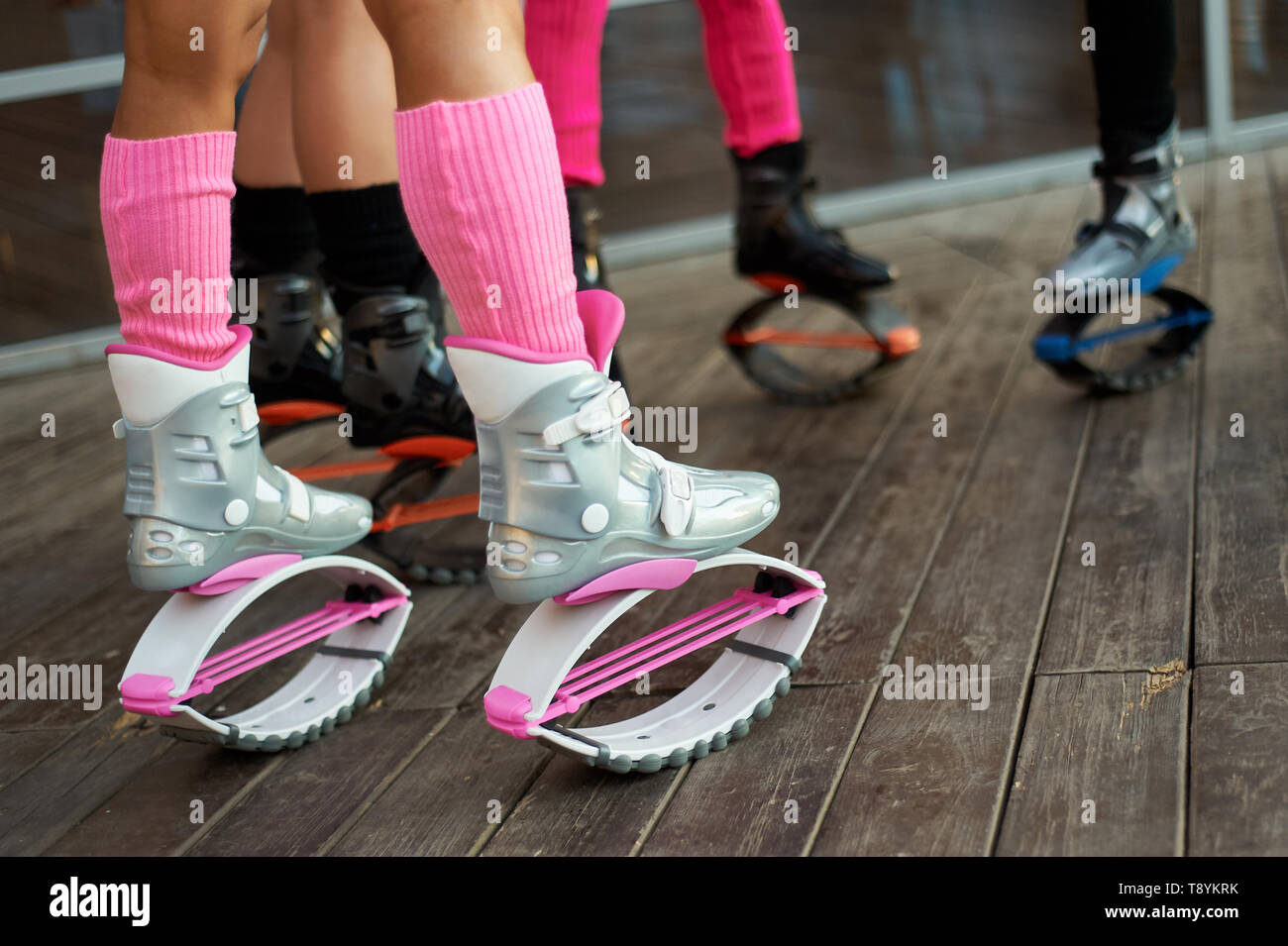 group of womens legs in kangoo jumping boots. outdoor fitness