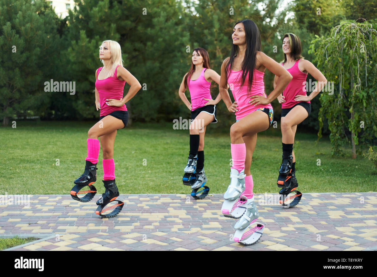 Female Trainer Doing Exercises Jumping In The Kangoo Jumps Boots
