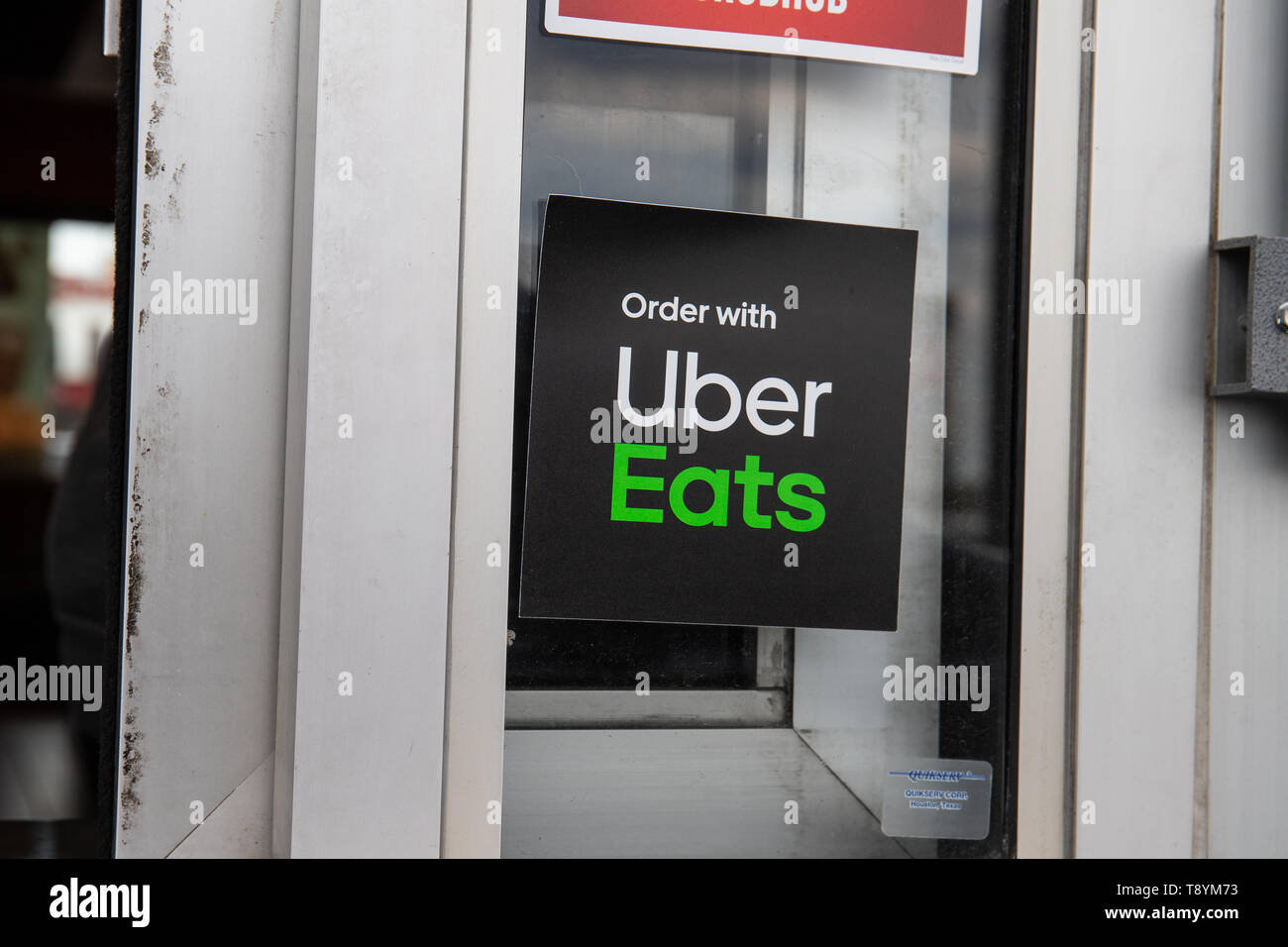 Indianapolis - Circa May 2019: Uber Eats badge on restaurant window. Uber Eats offers take out food delivery I Stock Photo