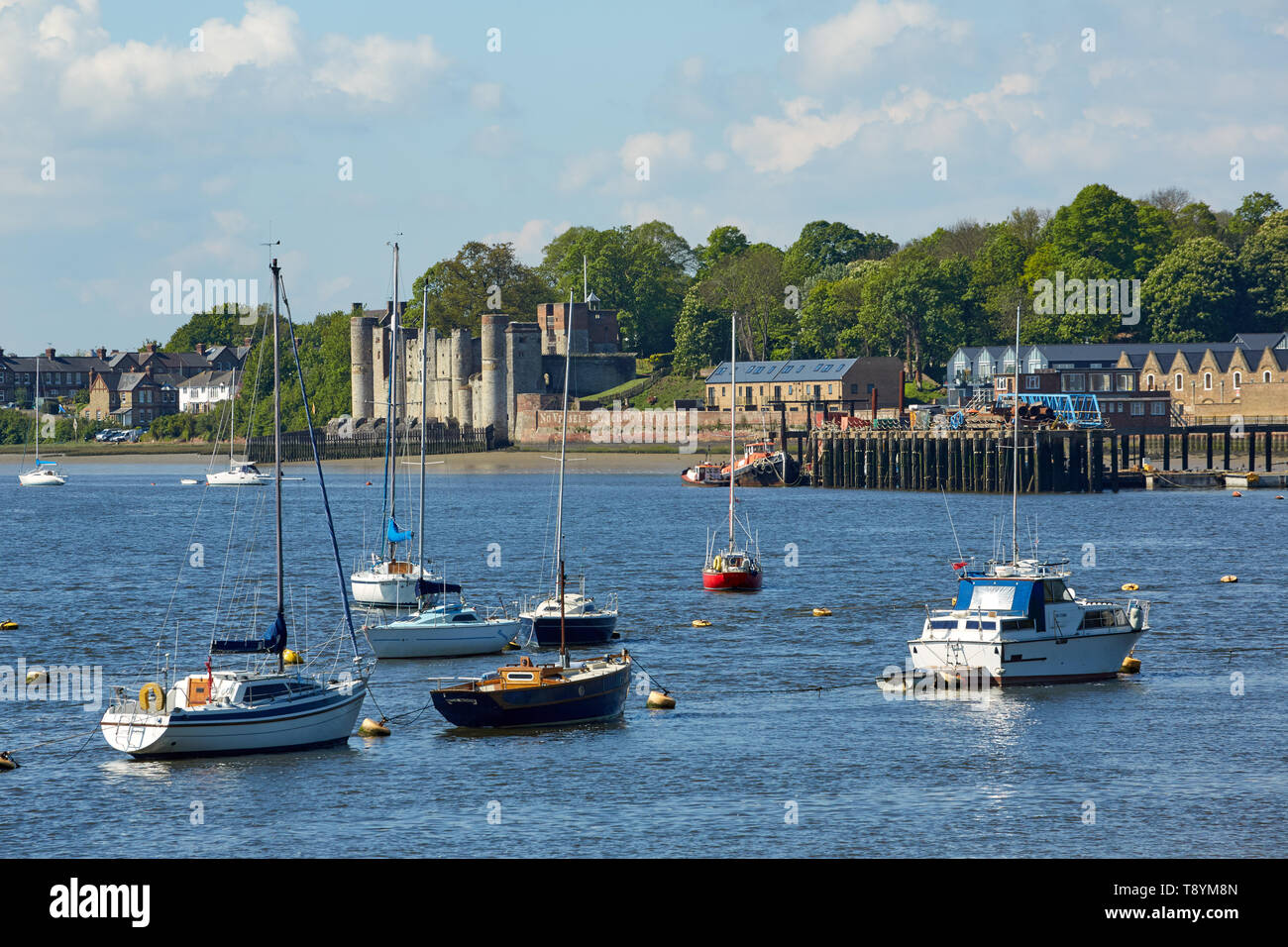 Yachts at moorings on the River Medway at Lower Upnor, Kent,UK. Showing Upnor Castle in the distance. Stock Photo