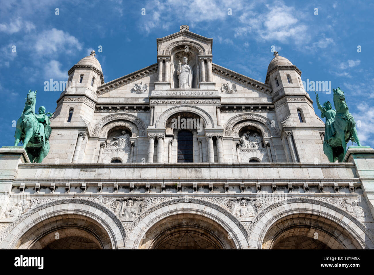 Detail showing equestrian statues (Saint Louis of France and Saint Joan of Arc) on façade of Sacre-Coeur Basilica in Montmartre, Paris, France Stock Photo