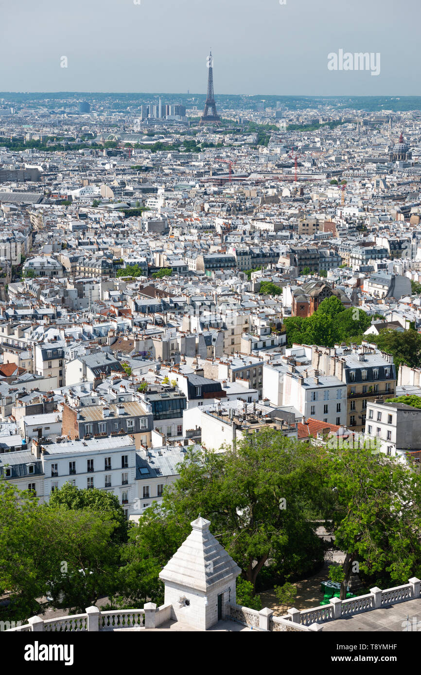 View of city skyline, with Eiffel Tower in distance, from top of Sacre