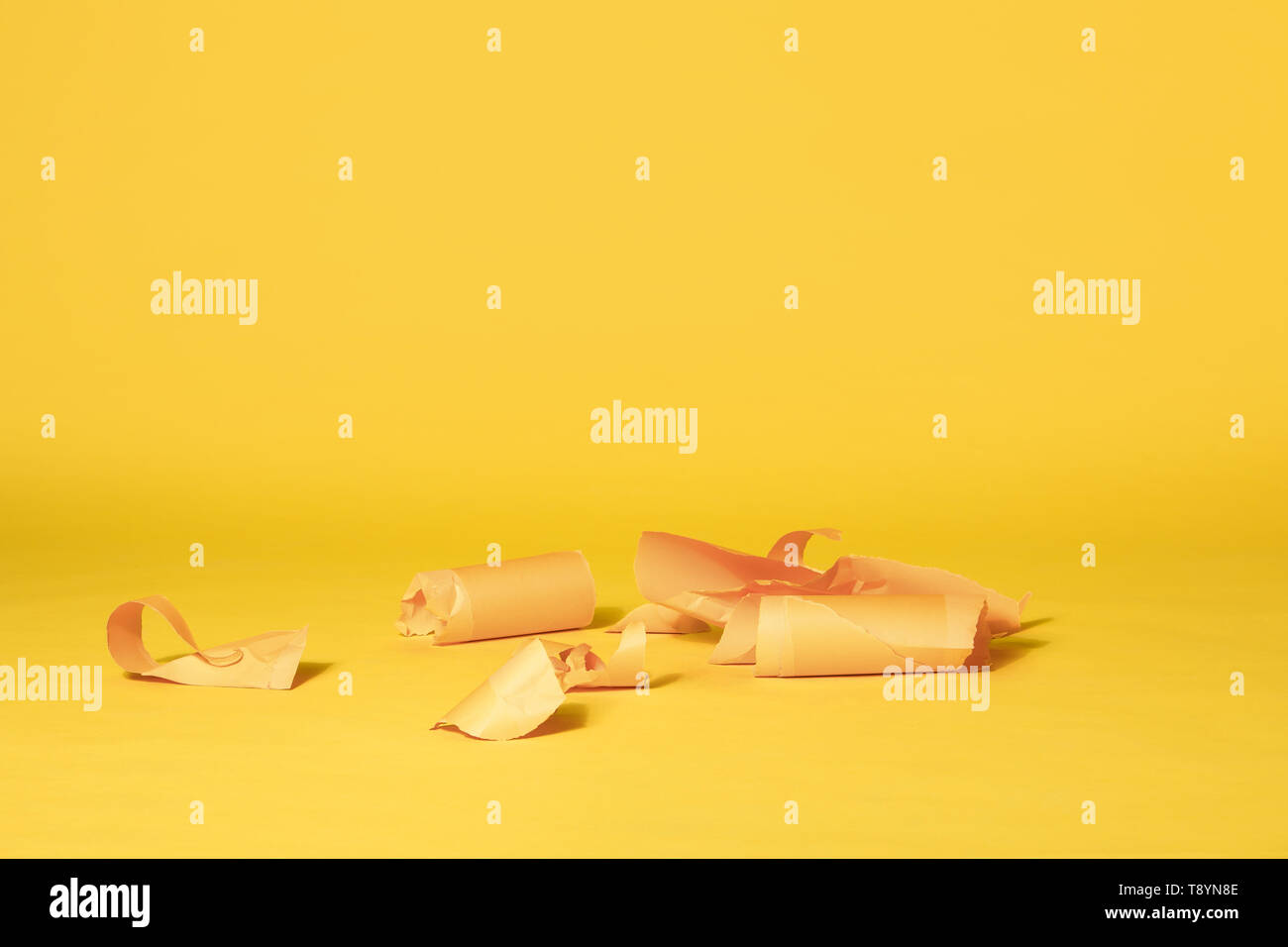 Various Stripes of Yellow Paper Left on Vibrant Yellow Seamless Background Stock Photo