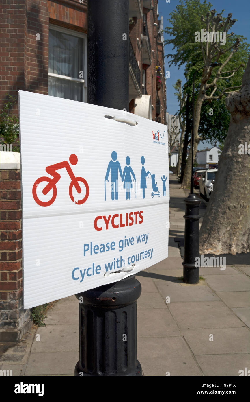 hammersmith and fulham council sign on the thames path asking cyclists