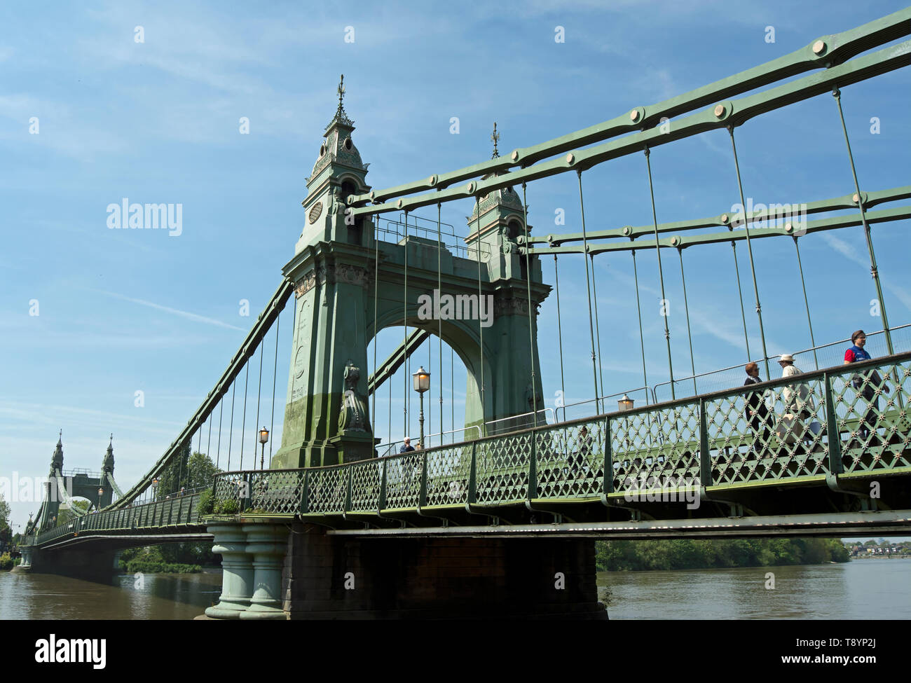 pedestrians use the footway of hammersmith bridge, crossing the river thames between barnes and hammersmith, london, england Stock Photo