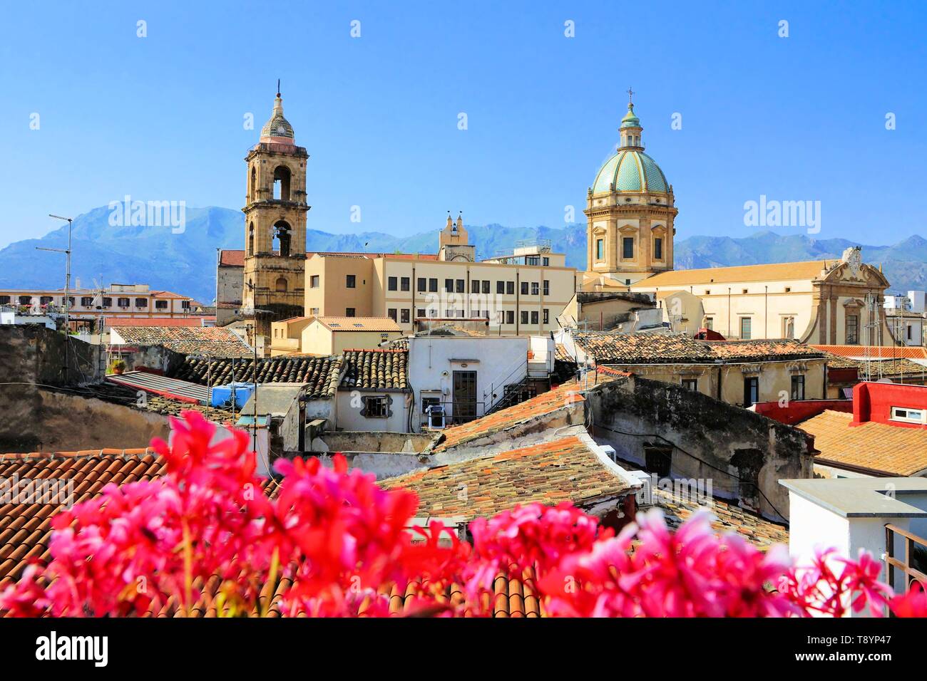 View over the rooftops and churches of Palermo, Sicily with vibrant flowers Stock Photo