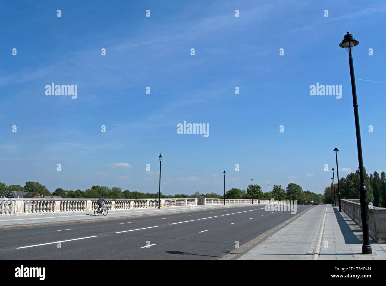 looking north on chiswick bridge, crossing the river thames in southwest london, england, with cyclist on far side Stock Photo