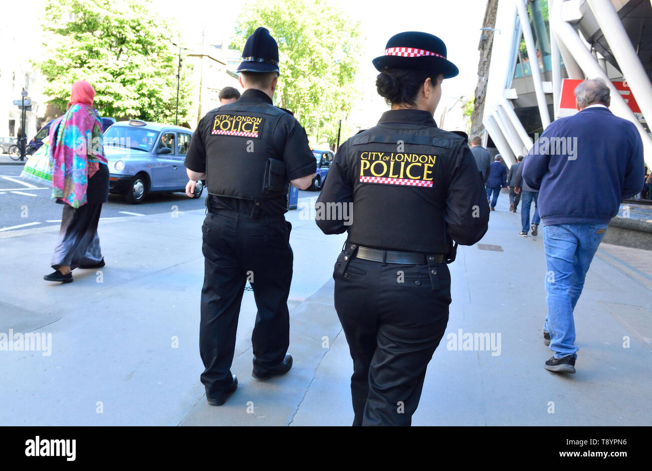 London, England, UK. Two City of London Police officers on patrol in Holborn - one male, one female Stock Photo