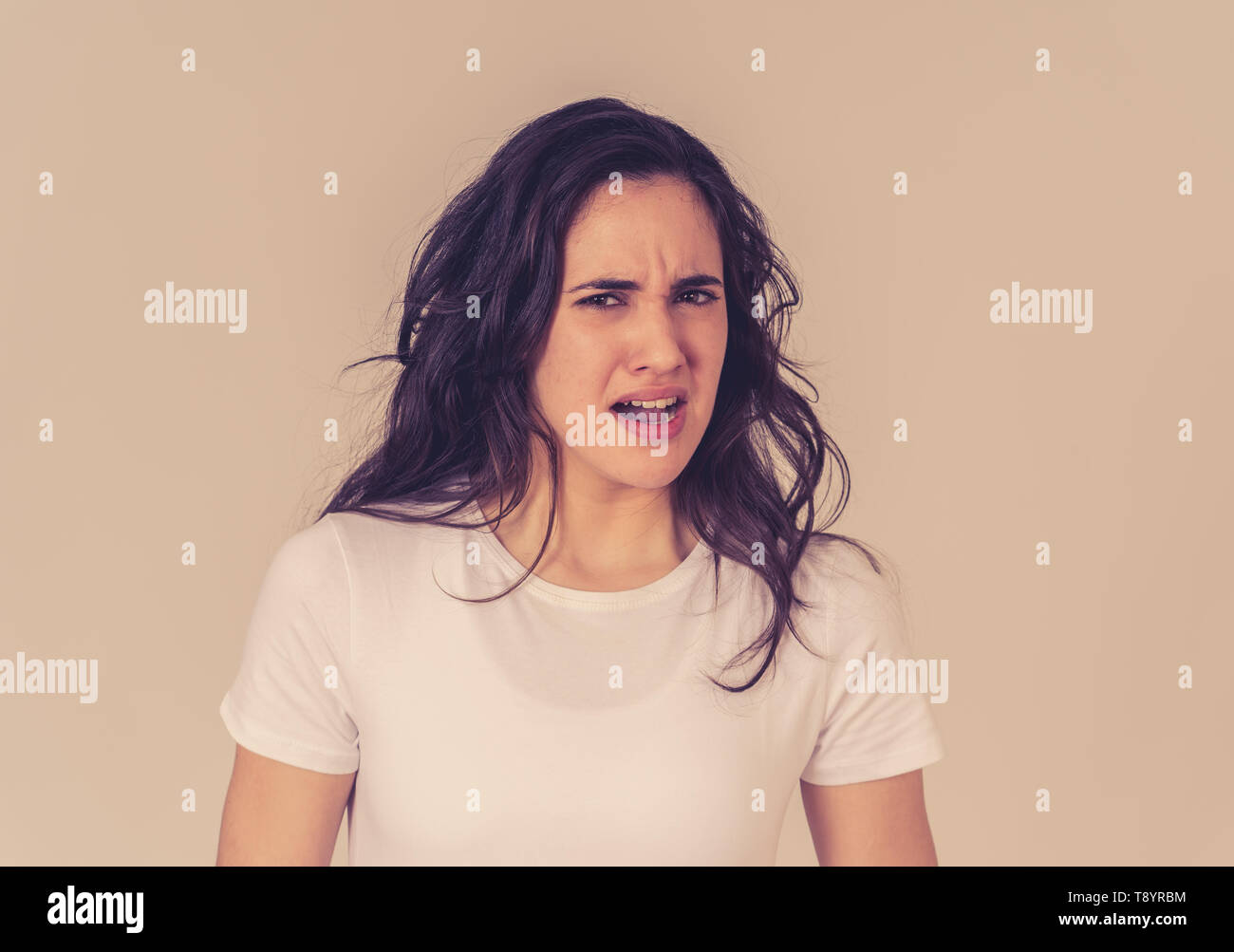 Young latin woman feeling disgust looking at something unpleasant making fear, anxiety gestures trying to cover herself in shock. Portrait with copy s Stock Photo