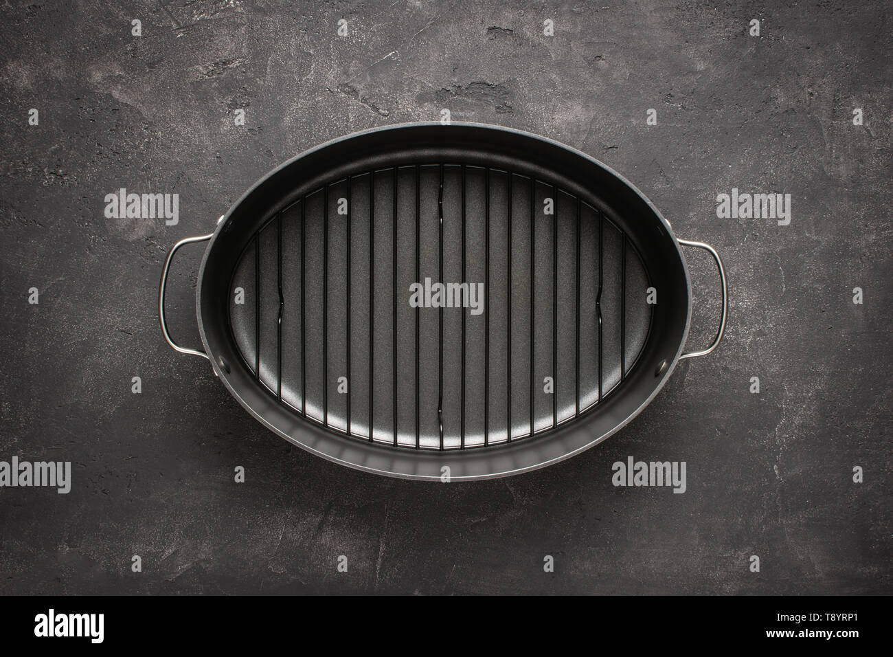 Empty Gray Nonstick Baking Dish with Handles on Dark Stone Surface. Culinary Background. Stock Photo