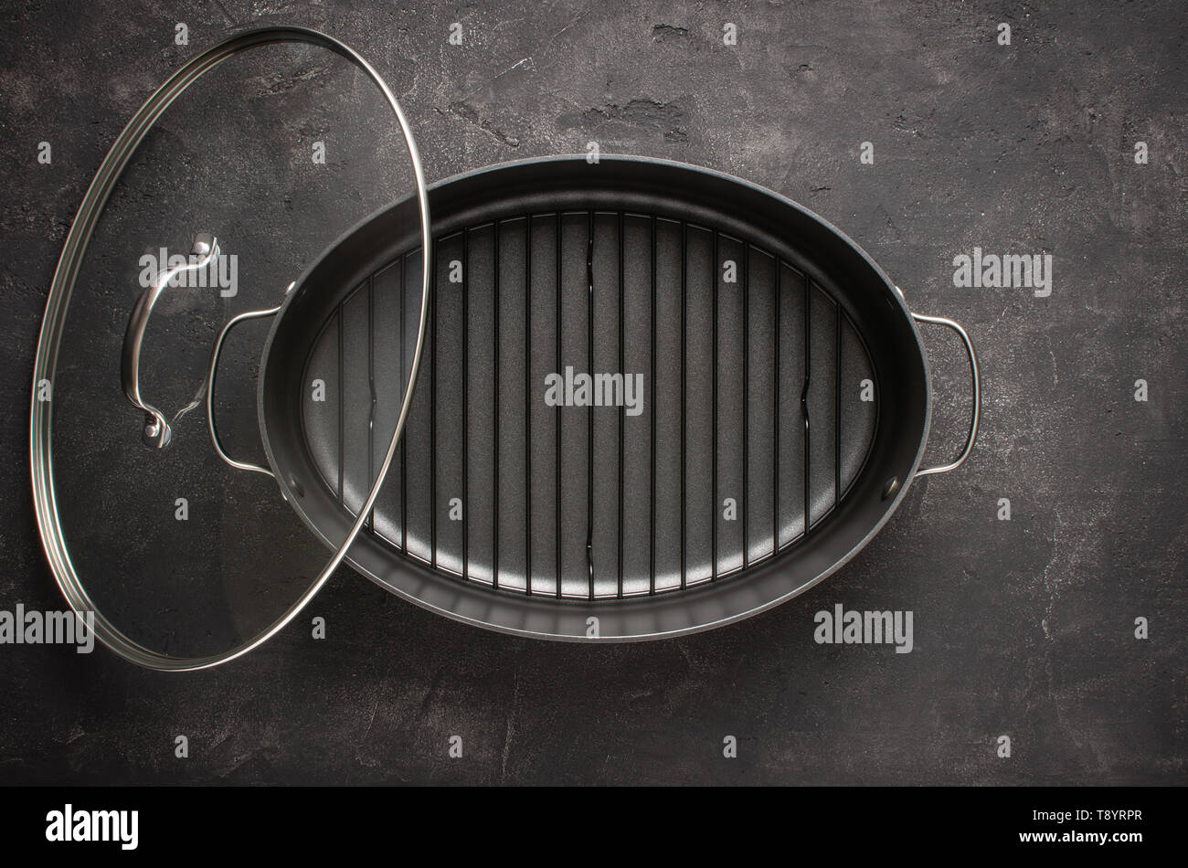 Empty Gray Nonstick Baking Dish with Handles on Dark Stone Surface. Culinary Background. Stock Photo