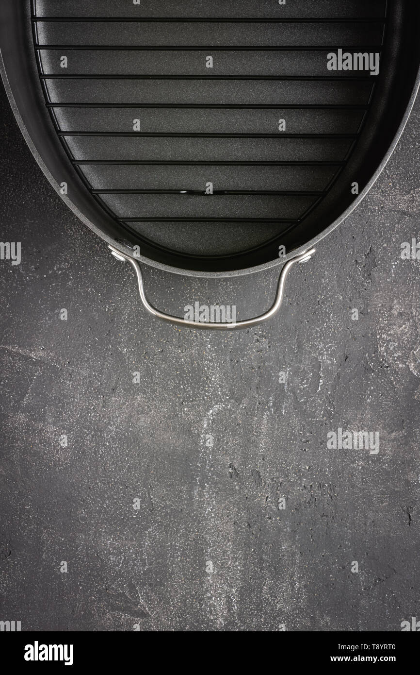 Empty Gray Nonstick Baking Dish with Handles on Dark Stone Surface. Culinary Background. Stock Photo