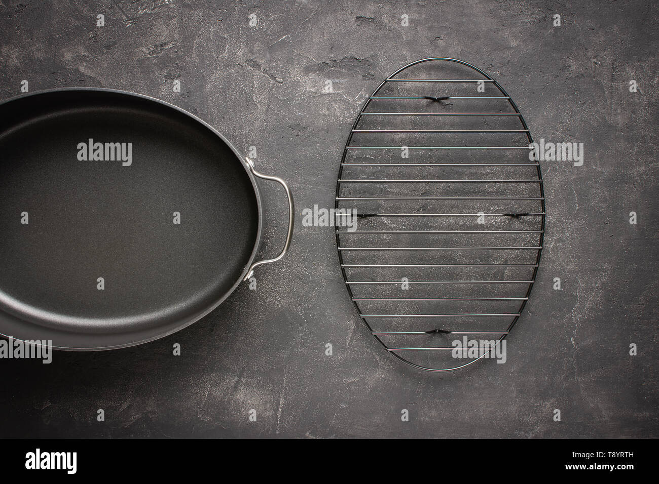 Empty Gray Nonstick Baking Dish with Handles on Dark Stone Surface. Culinary Background. Stock Photo