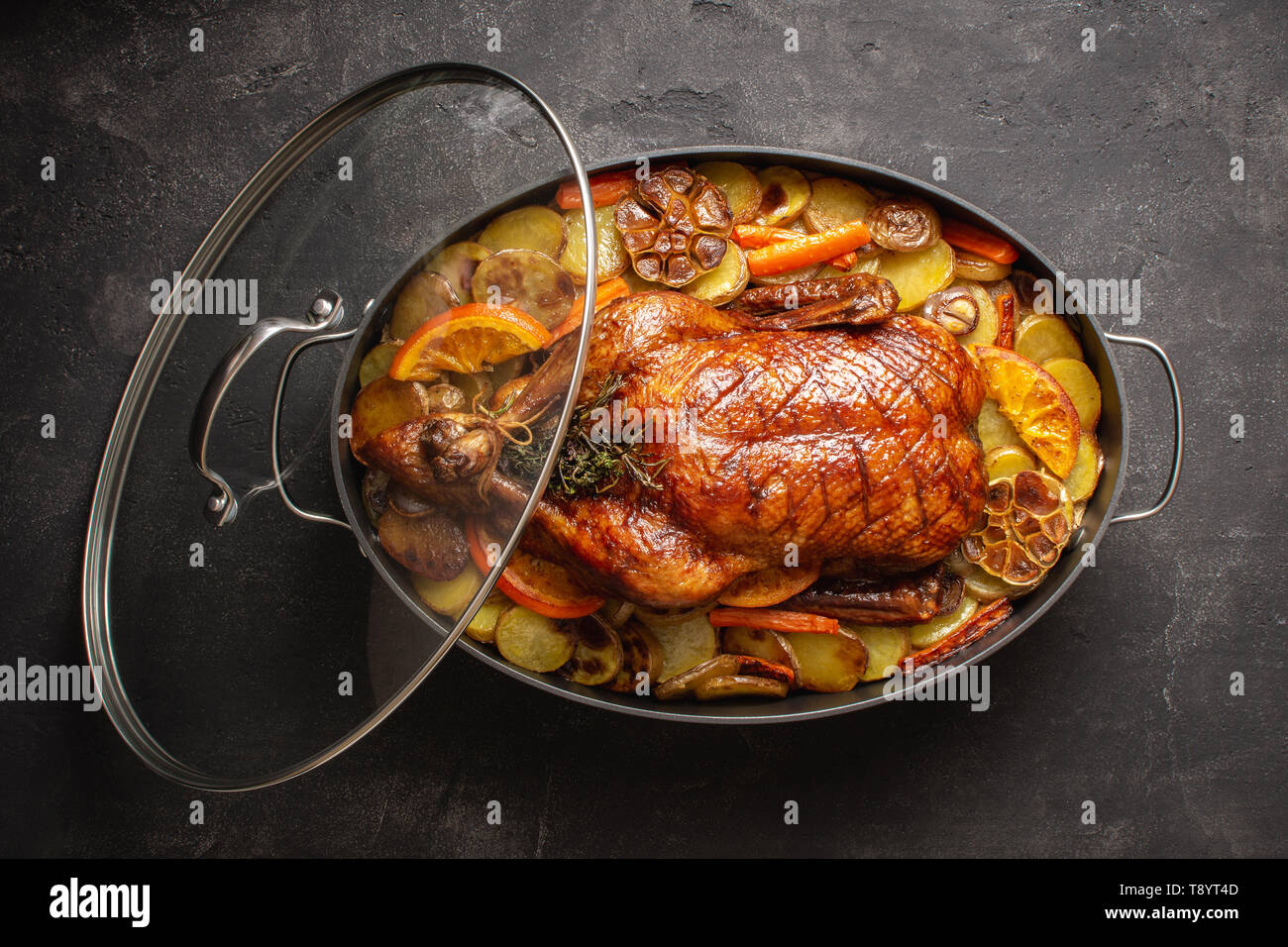 Christmas Duck Baked with Potatoes, Carrots and Oranges. Festive Food Concept. Stock Photo