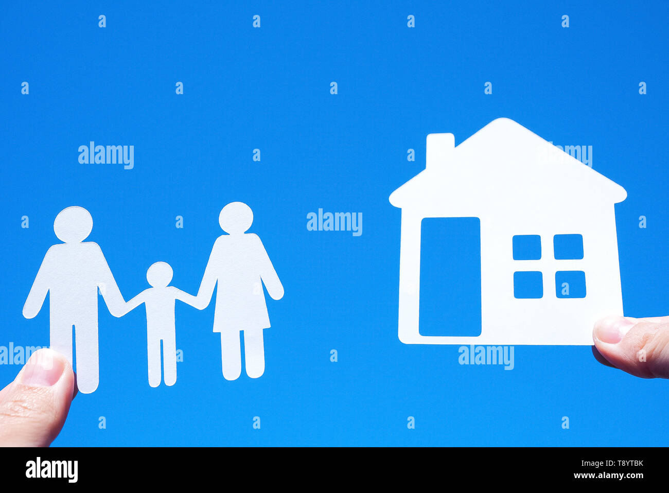 Paper family on blue sky background Stock Photo - Alamy