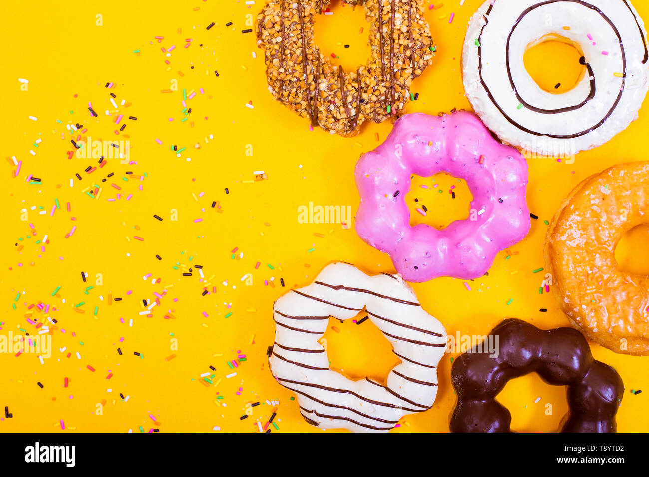 Colorful Donuts on yellow  background. Stock Photo