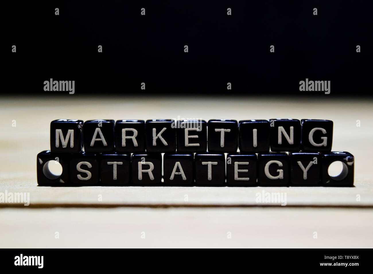 Marketing Strategy concept wooden blocks on the table. With personal ...