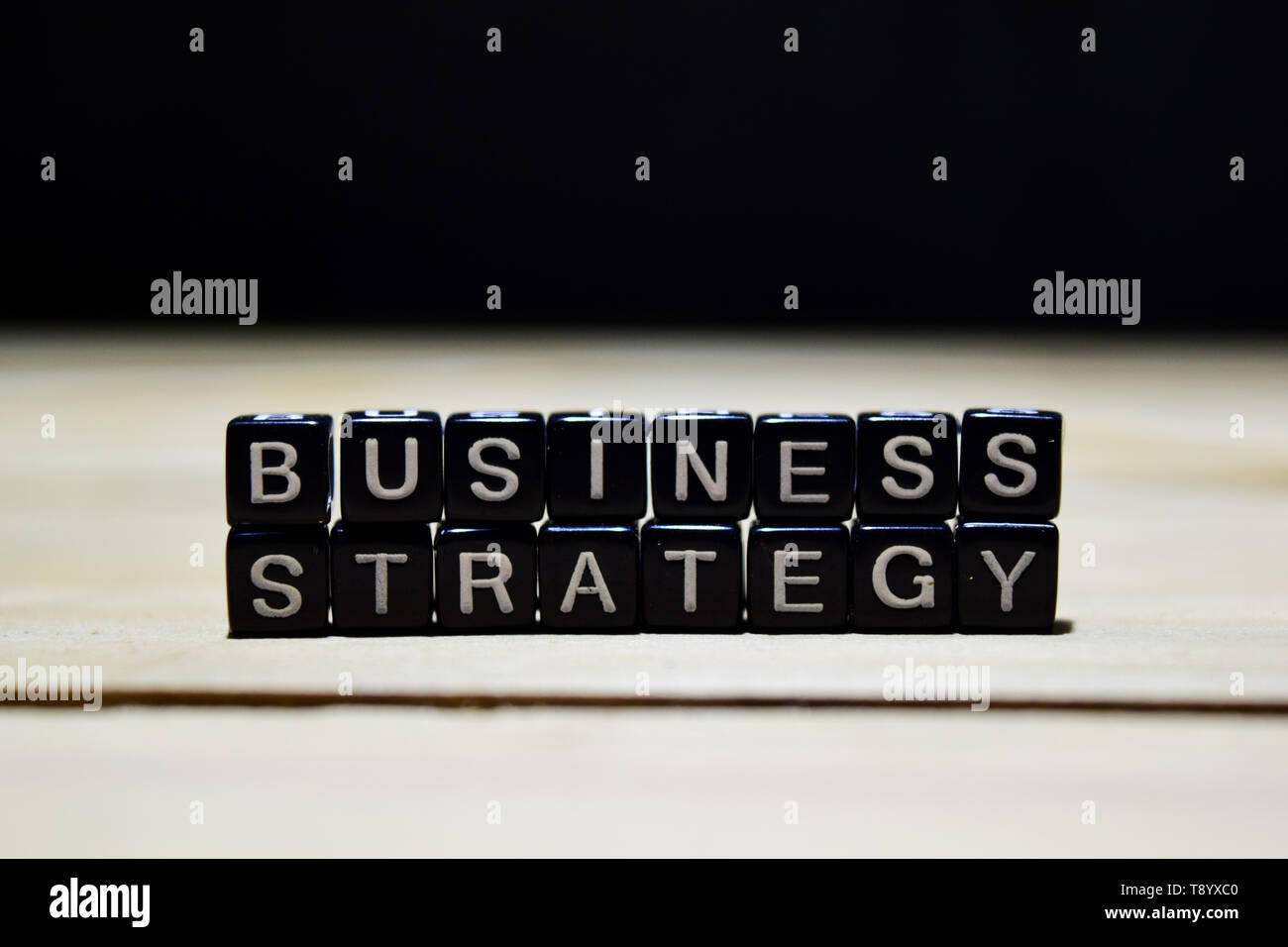 Business Strategy concept wooden blocks on the table. With personal ...