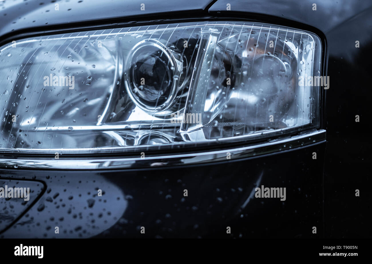 Wet car headlight. Stock Photo