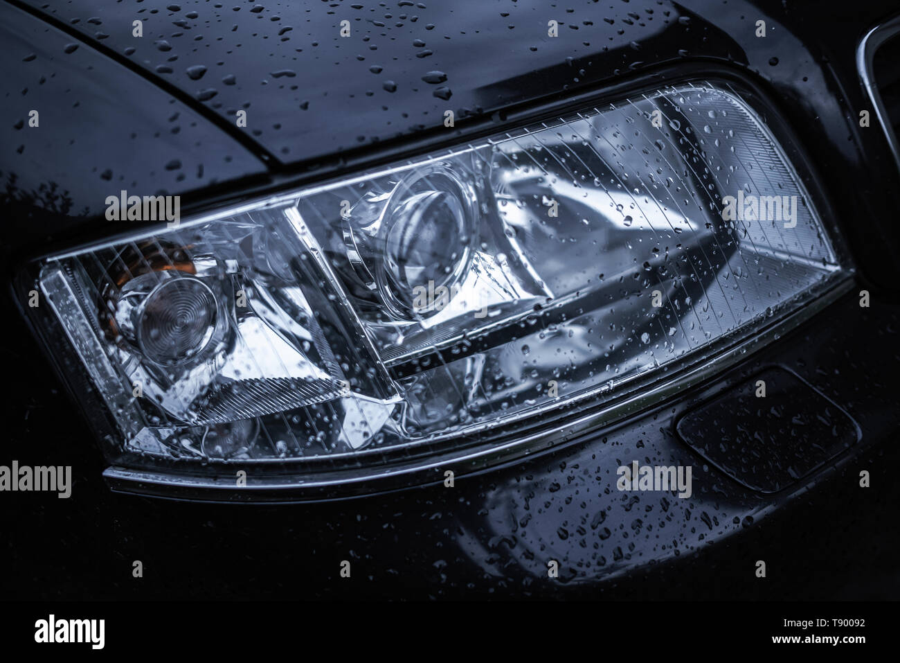 Wet car headlight. Stock Photo