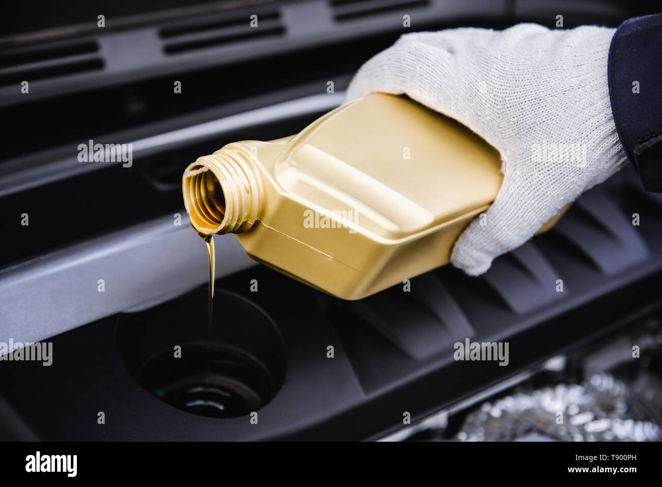 pouring engine oil into a car engine Stock Photo Alamy