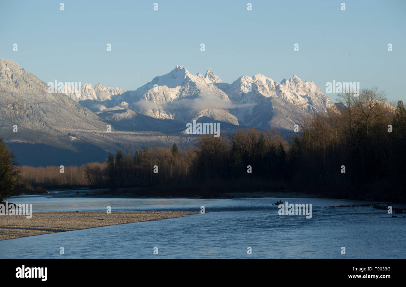 Cascade Mountains and Skykomish River viewed from bridge crossing the river at Sultan, Washington. Stock Photo