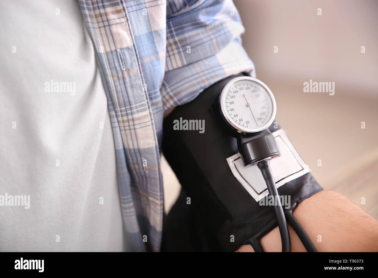 Young man measuring his blood pressure at home Stock Photo - Alamy