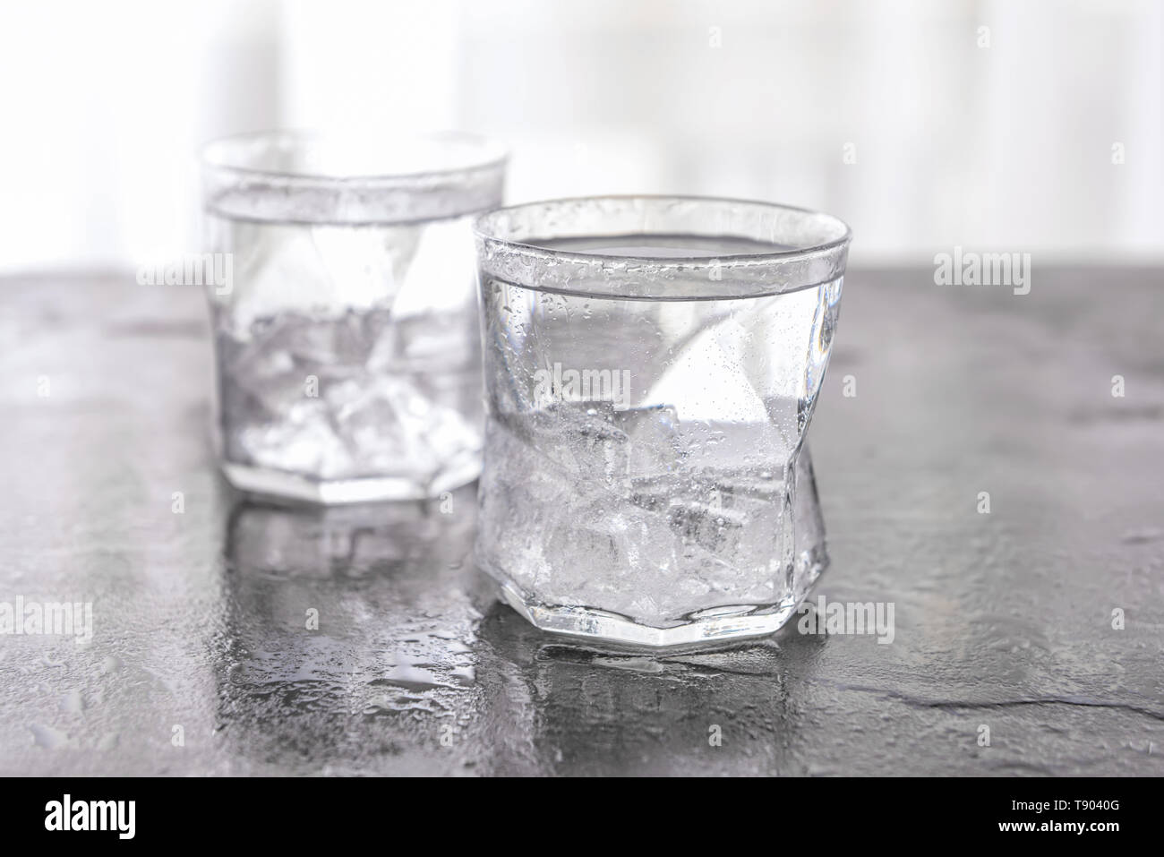 Glass of cold water on grey table Stock Photo - Alamy