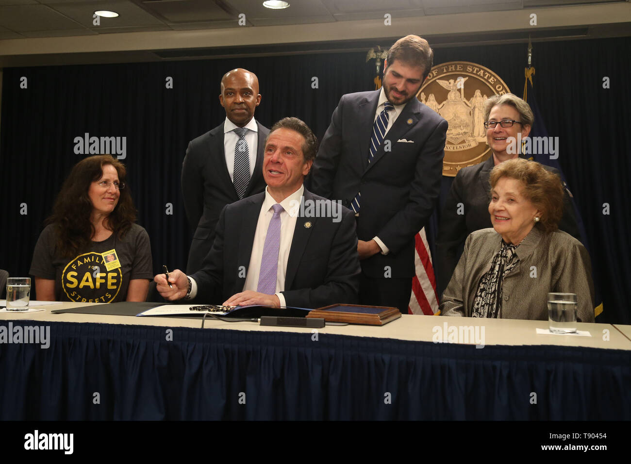 May 12, 2019 - New York, NY, USA - May 12, 2019 -  Governor Andrew M. Cuomo signed legislation at a press conference to set up speed cameras in front of New York schools at  the New York State Offices on 633 3rd Avenue. Clockwise : Founder of Families For Safe Streets  Amy Cohen, Counsel to the Governor Alphonso David, State Senator D-22 Andrew Gounardes , NY State Assemblywoman D-66 Deborah Glick, and Matilda Cuomo surround Governor Andrew Cuomo as he signs the bill. (Credit Image: © Dan Herrick/ZUMA Wire) Stock Photo