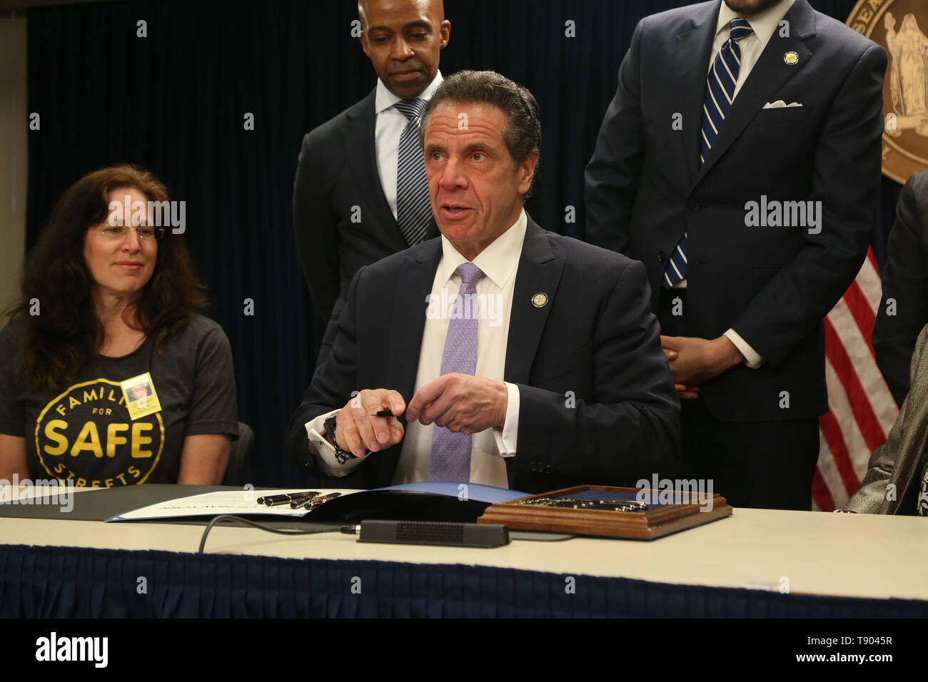 May 12, 2019 - New York, NY, USA - May 12, 2019 -  Governor Andrew M. Cuomo signed legislation at a press conference to set up speed cameras in front of New York schools at  the New York State Offices on 633 3rd Avenue.Founder of Families For Safe Streets  Amy Cohen, Counsel to the Governor Alphonso David, and Governor Andrew Cuomo as he signs the bill. (Credit Image: © Dan Herrick/ZUMA Wire) Stock Photo